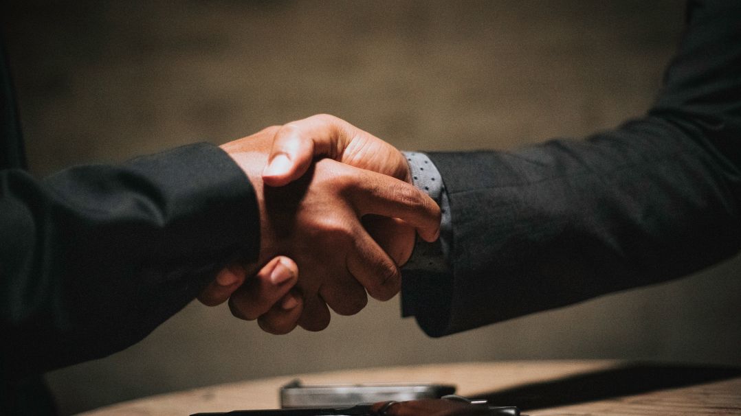 shaking hands during business meeting